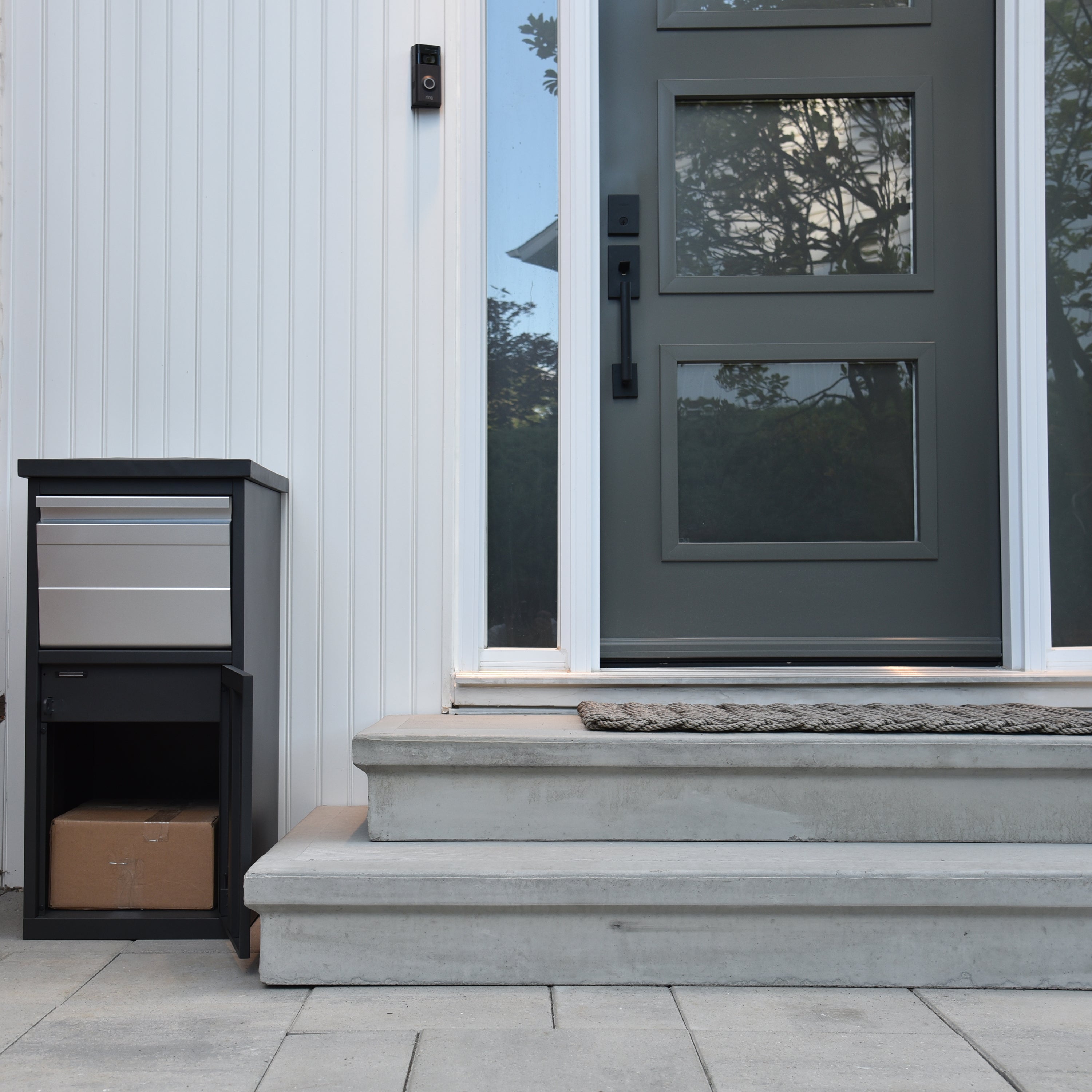 Parcelwirx drop box with chute open with parcel inside on a front porch