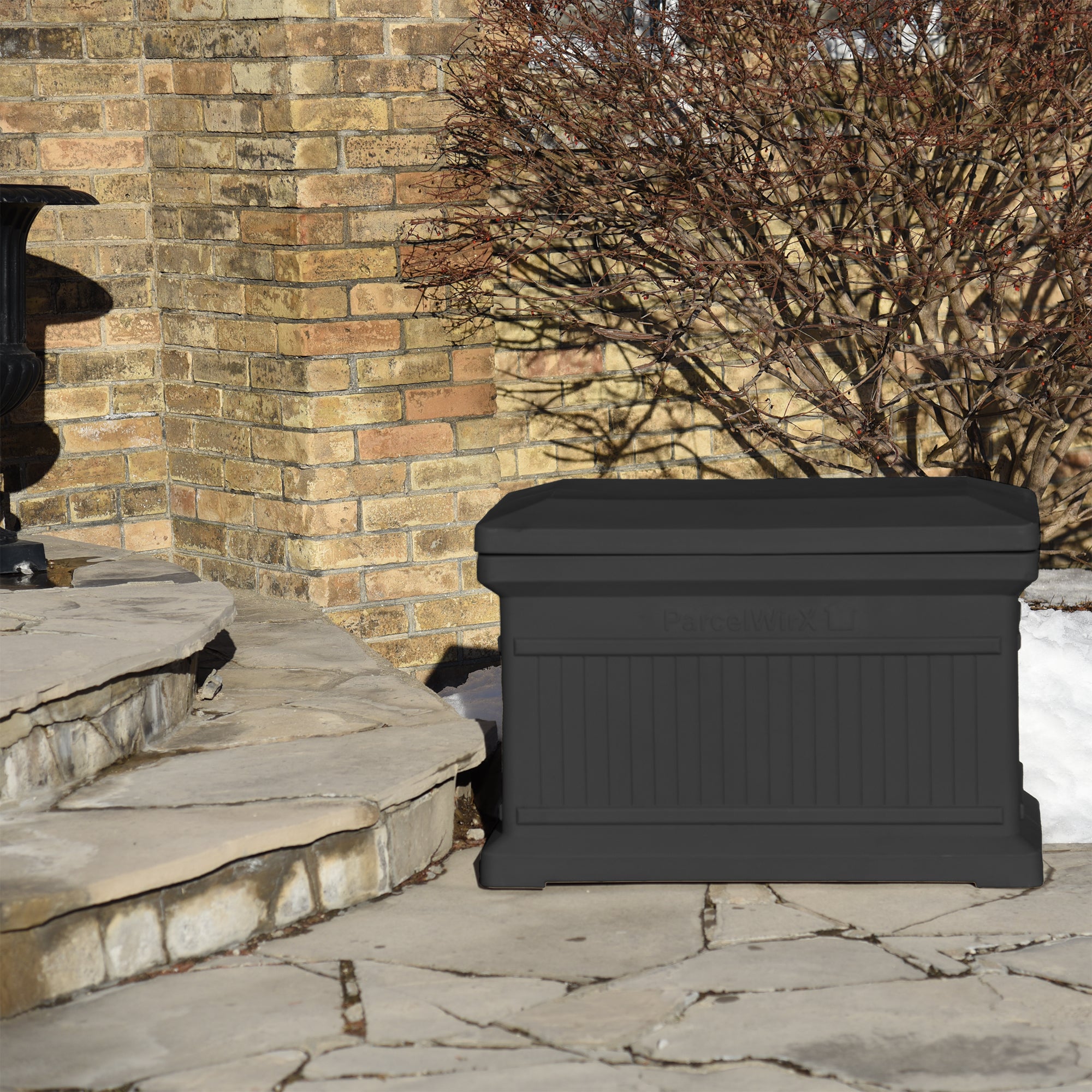 Graphite ParcelWirx horizontal standard from the front with the lid on, on front porch