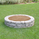Four pieces of curved rock lock making a circular sandbox with sand inside