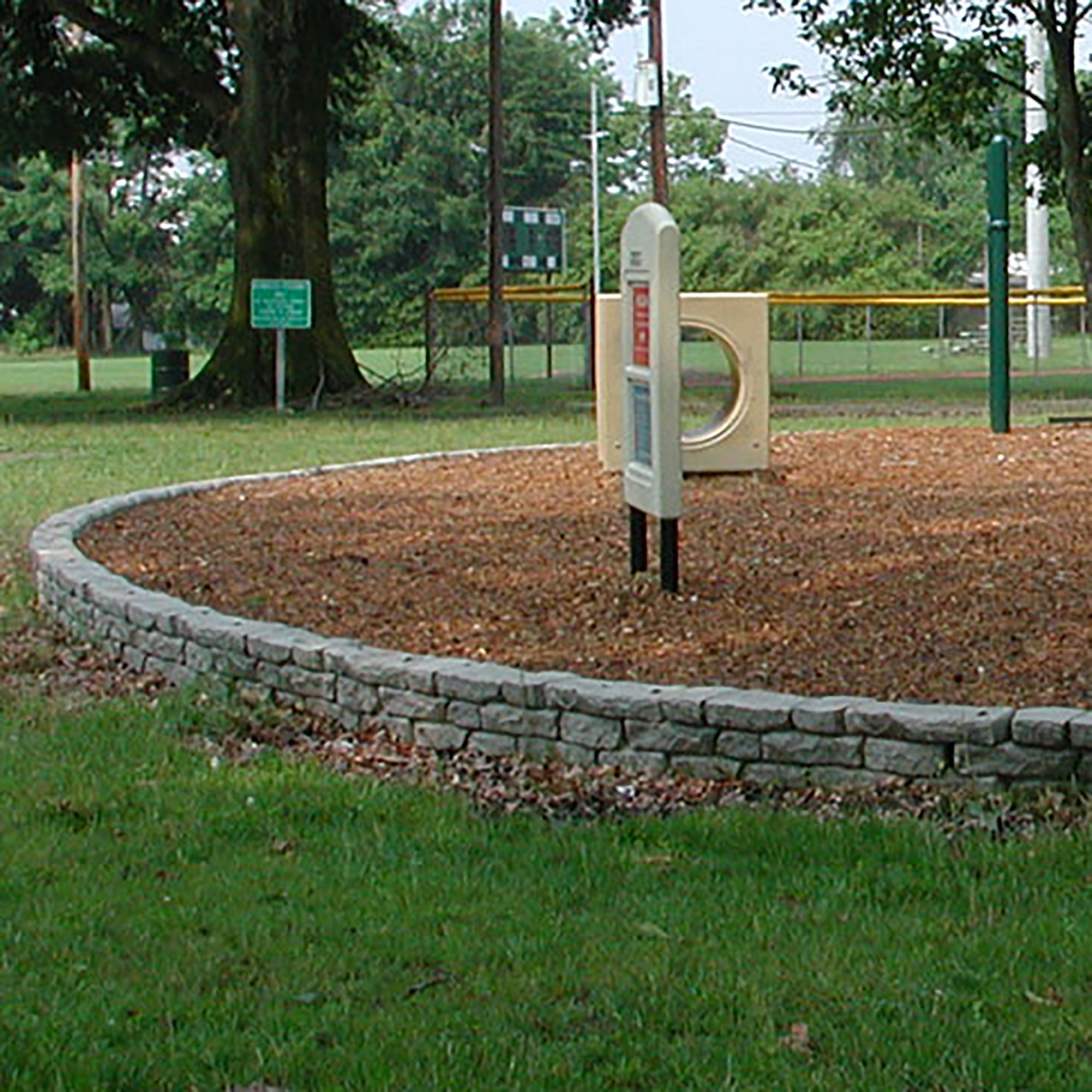 Curved and straight rock lock assembled together to make a border around playground