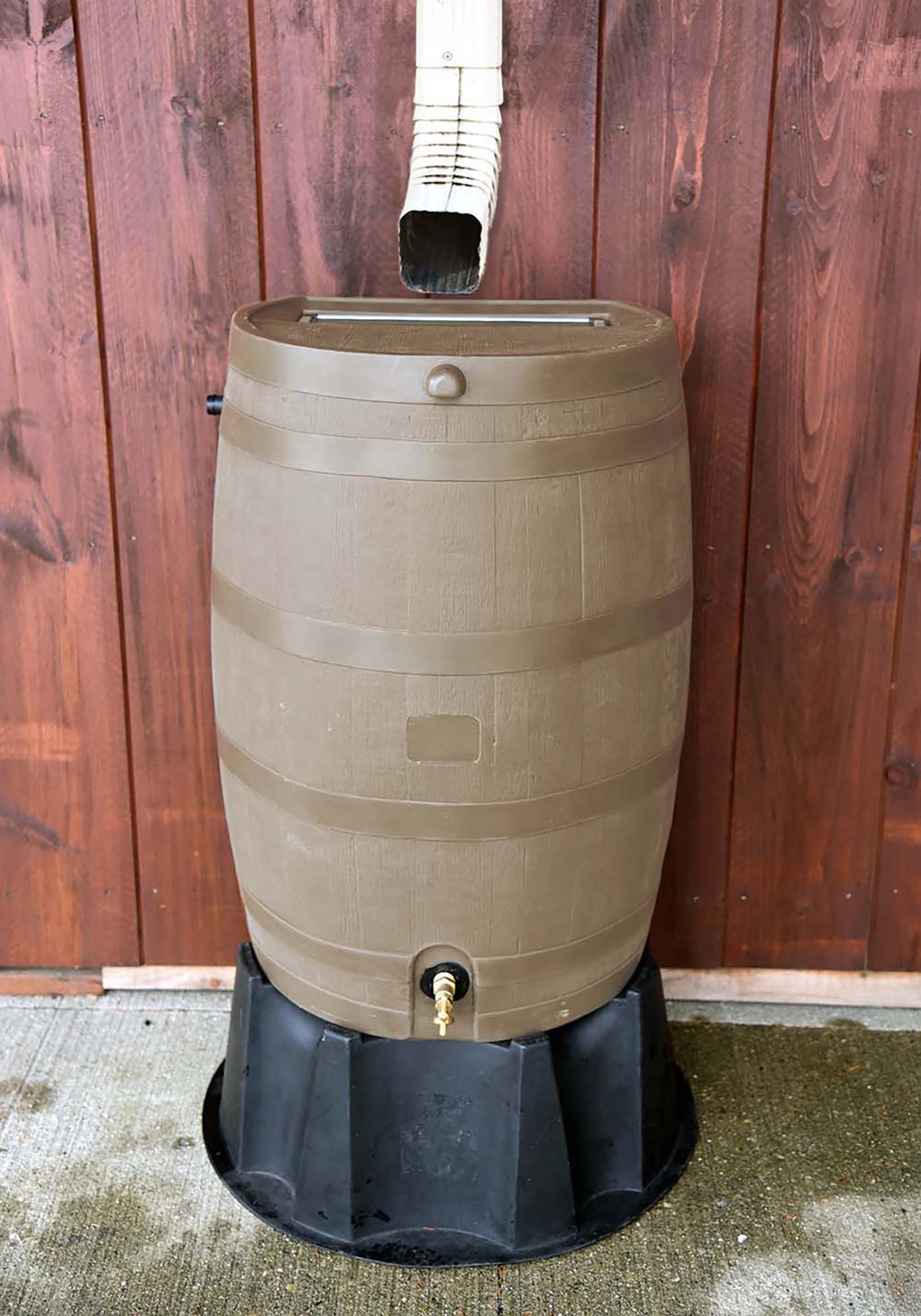 oak flat back rain barrel on black stand with wood background