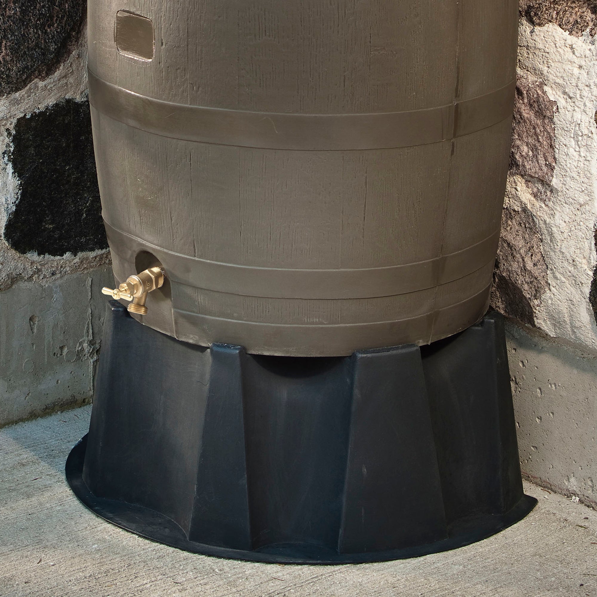 close up of brass spigot on brown rain barrel